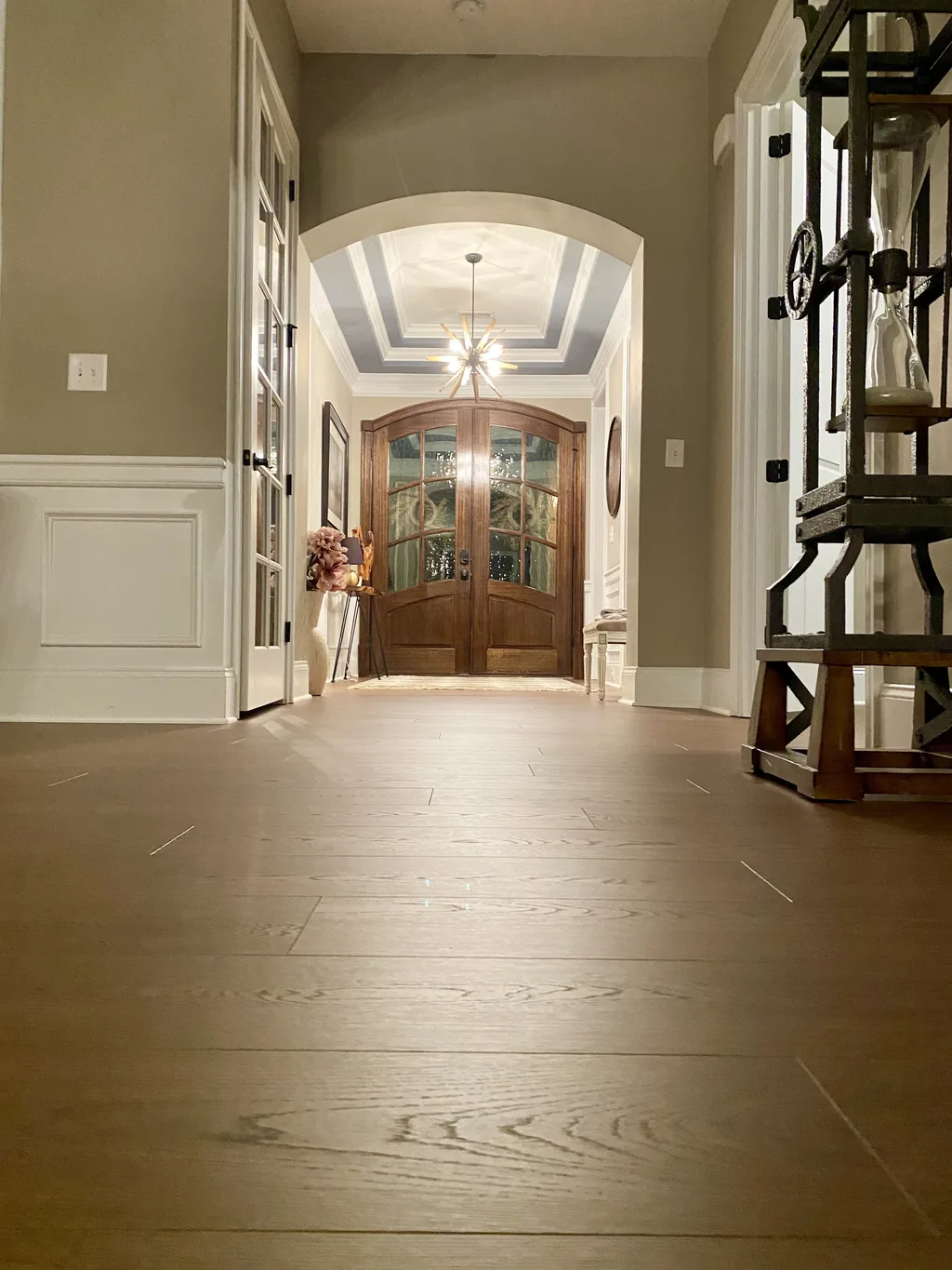 Wood-look plank flooring in an entry hallway leading to a double front door